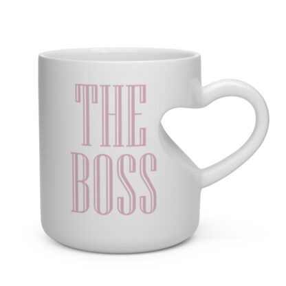 Left of ceramic mug with heart shaped handle and pink print of "THE BOSS"